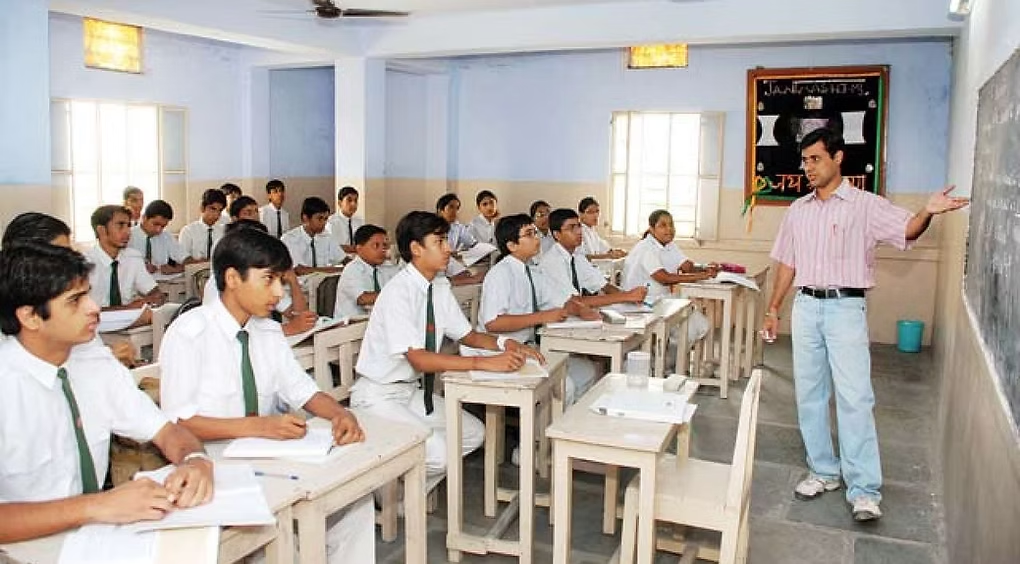 An educator discussing a lesson with students in a classroom